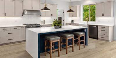 Kitchen design with wood look flooring and white waterfall countertop